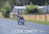 a man in a wheelchair is driving down a road with the words code one written on the bottom