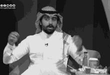 a black and white photo of a man with almajdchannels written on the bottom right corner