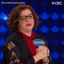 a woman with glasses and a name tag that says christine on it