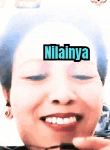a close up of a woman 's face with nilainya written on her face