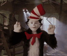 a cat in the hat costume with a red bow tie