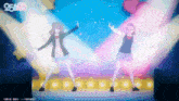two anime girls are dancing on a stage with the number 25 in the corner