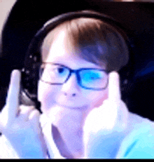 a man with glasses and headphones is giving the middle finger .