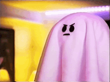two pink ghosts with angry faces on them are standing next to each other in a room .
