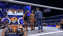 a group of wrestlers are standing in a wrestling ring with a sign that says aew