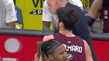 a basketball player wearing a jersey that says al maro is talking to another player