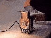 a person is working on a device that looks like a toaster oven