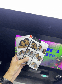 a person is holding a photo booth with the words ok a foto on the screen