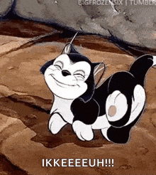 a black and white cartoon cat is smiling and crawling on a rock .