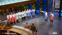 a group of people standing in a circle with a nbc logo on the bottom right