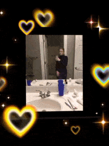 a picture of a woman taking a selfie in a bathroom