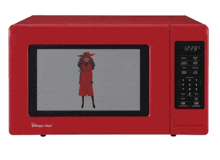 a red magic chef microwave shows a woman in a red coat and hat