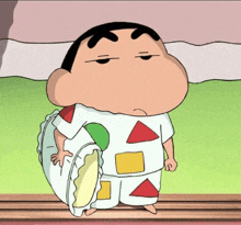 a cartoon character is holding a pillow in his hand while wearing pajamas .