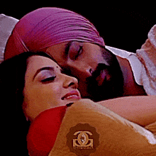 a man in a turban is laying on a woman 's shoulder