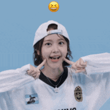 a girl wearing a baseball cap and a jersey that says ' argentina '