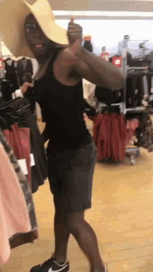a man wearing a hat and shorts is in a clothing store