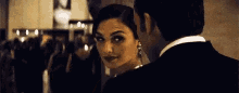 a man and a woman are standing next to each other in a room .
