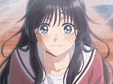 a close up of a girl 's face with a sad look on her face