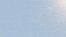 a futuristic fighter jet is flying through a blue sky