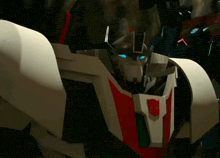 a close up of a robot with a red and white stripe on it