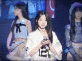a girl wearing a white shirt with the number 12 on the front
