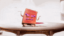 a book with a face and arms is standing on a table