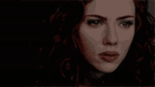 a close up of a woman 's face with red hair
