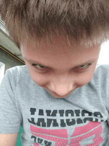 a boy wearing a t-shirt that says " i am a ninja "