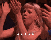 a woman with her hands in the air and a five star rating