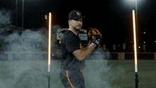 a baseball player is standing in front of a scoreboard that says clarksville