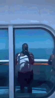 a man is taking a picture of himself in the mirror on a cruise ship