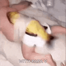 a person is laying on a bed with a baby on their chest .