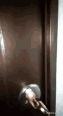 a person is taking a shower in a dark room with a shower head .