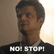 a man in a suit and tie says " no! stop "