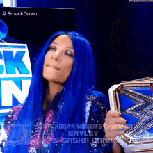 a woman with blue hair holding a smackdown women 's championship belt