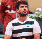 a man wearing a shirt that says np paribas on it