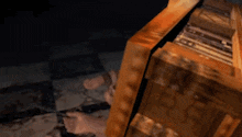 a person is laying on the floor in a dark room with a candle .