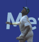 a baseball player catches a ball in front of a sign that says " home "