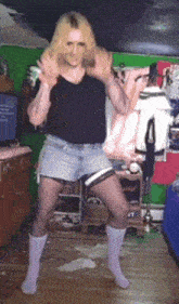 a man in shorts and socks is dancing in a room