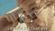 a man wearing sunglasses has the words i wanna see that ass below him