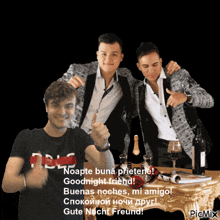 a group of men are posing for a picture with a bottle of wine in the background