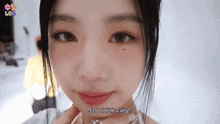 a close up of a woman 's face with korean writing on the bottom right