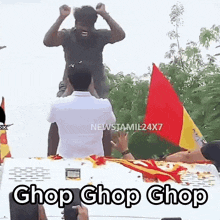 a man is sitting on top of another man 's head while a man takes a picture of him .