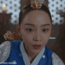 a close up of a woman wearing a traditional korean dress