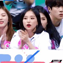 a group of people sitting in a stadium with a sign that says yeungif on it