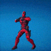 a deadpool action figure is standing in front of a blue sky