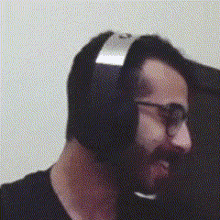 a man with a beard wearing a pair of headphones and glasses