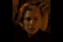 a close up of a person 's face with a gold mask on