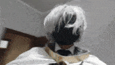 a man with white hair and a black face mask