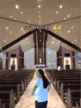 a woman stands in a church with the bible verse isaiah 60:22 written above her